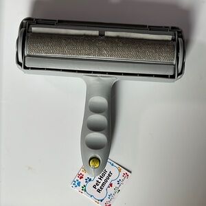 NWT pet hair remover roll the brush along any surface with pet hair and voila